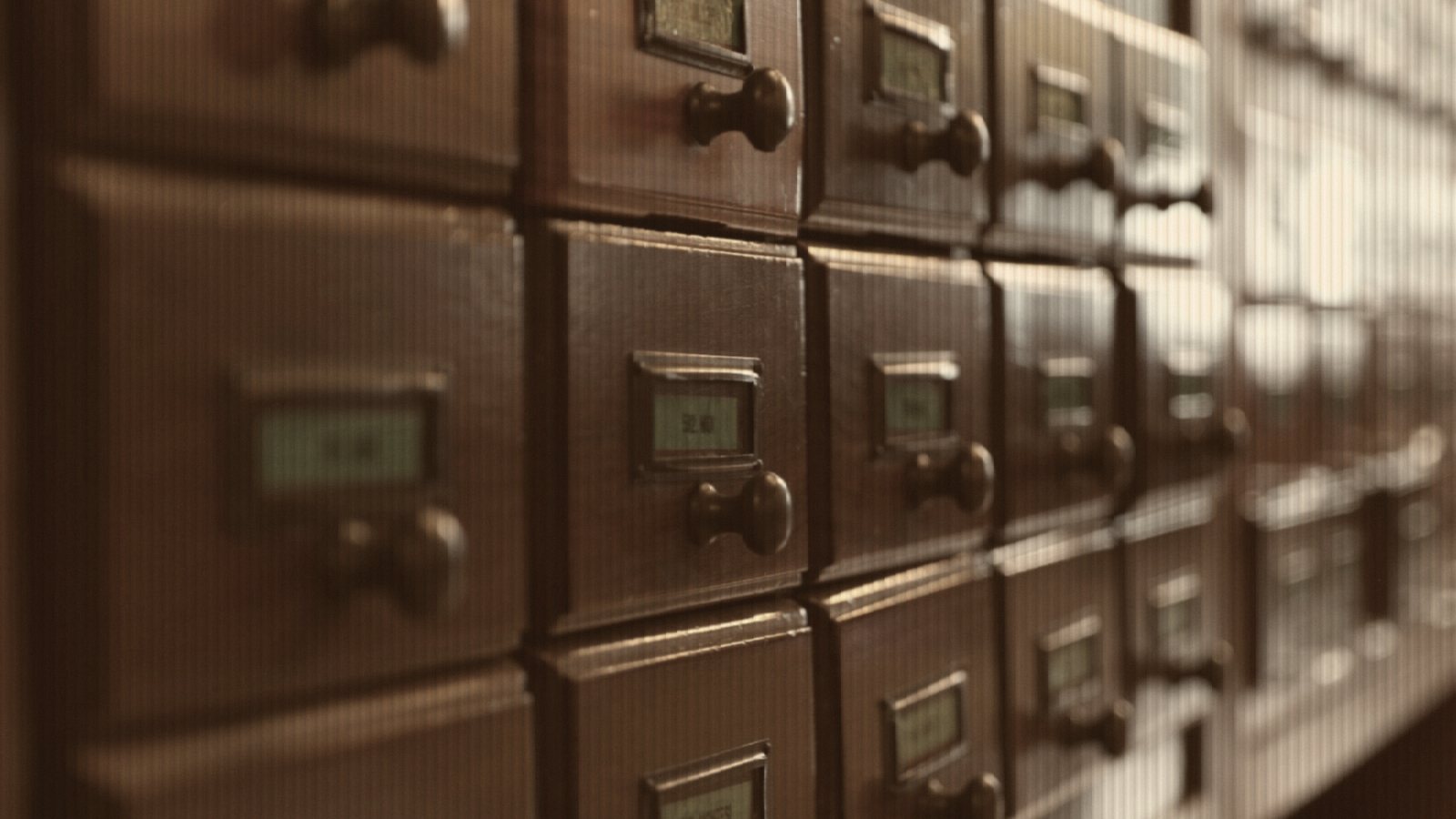 Vintage wooden card catalog drawers with labels