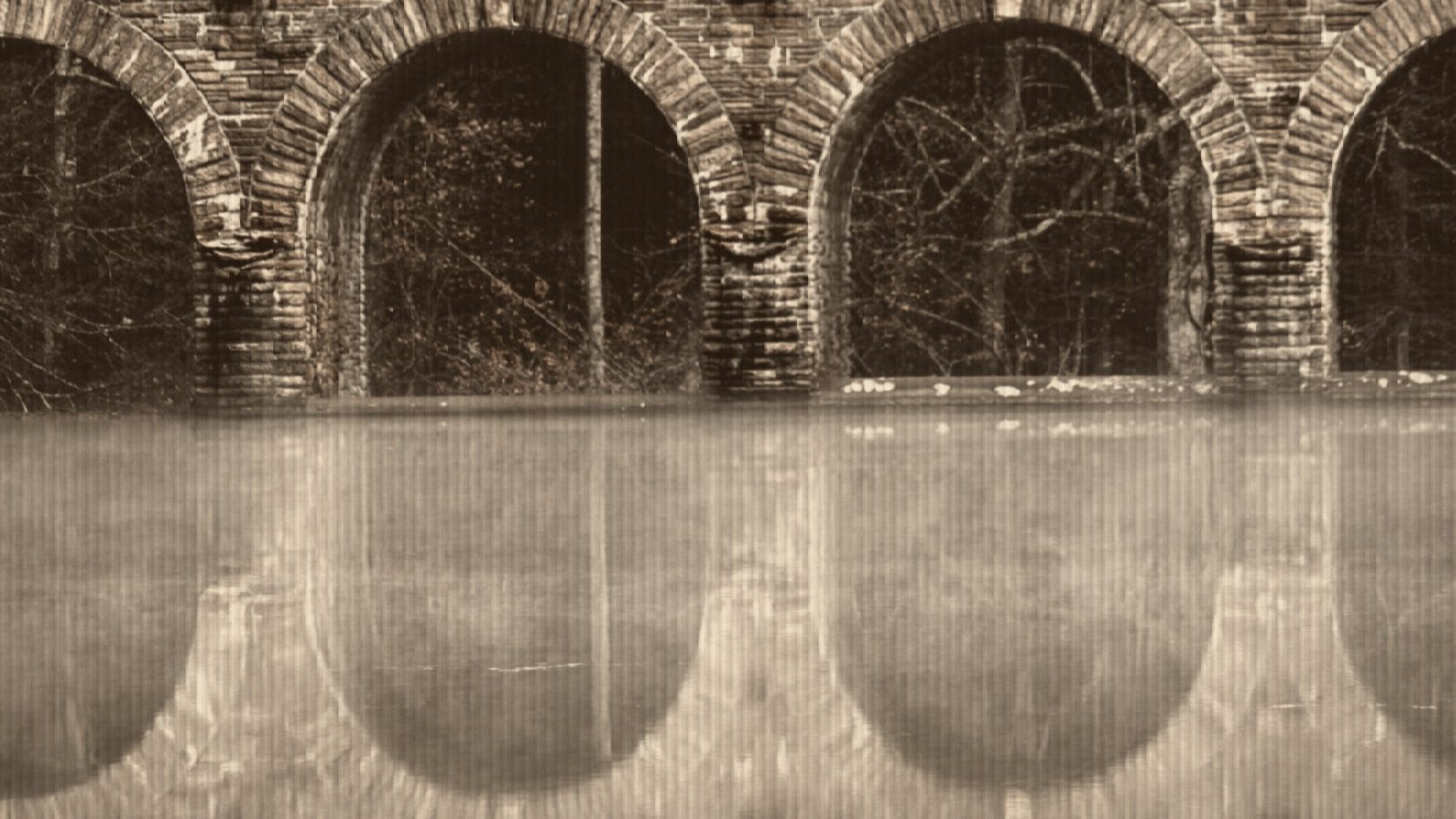 A stone wall with a stone arch