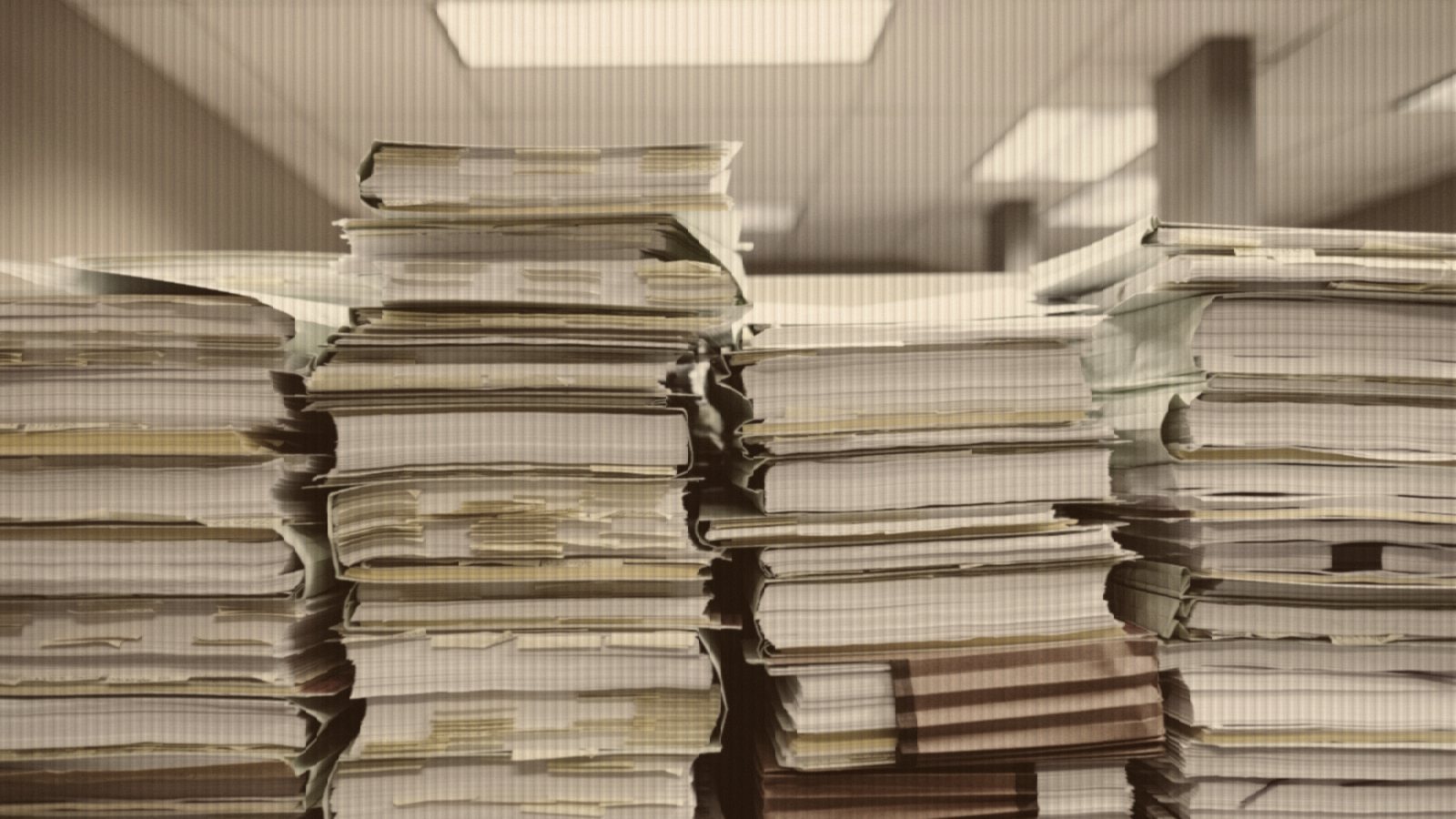 Stacks of paper documents and file folders