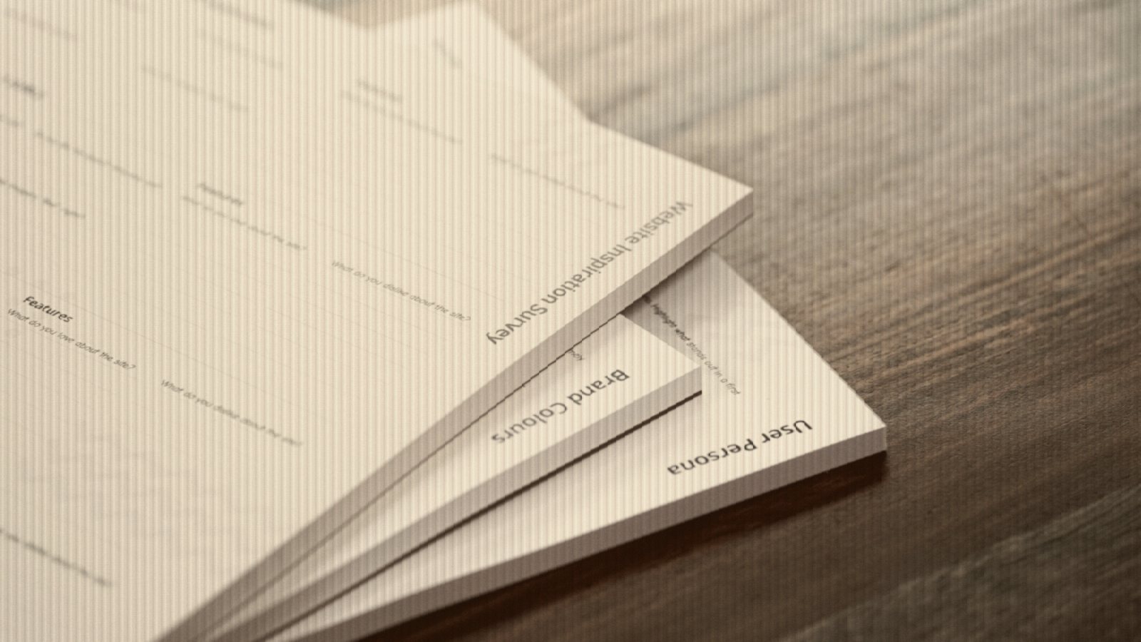 A stack of papers sitting on top of a wooden table