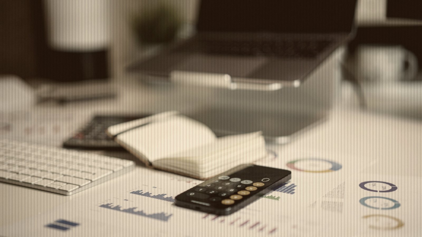 Office desk with smartphone and financial charts