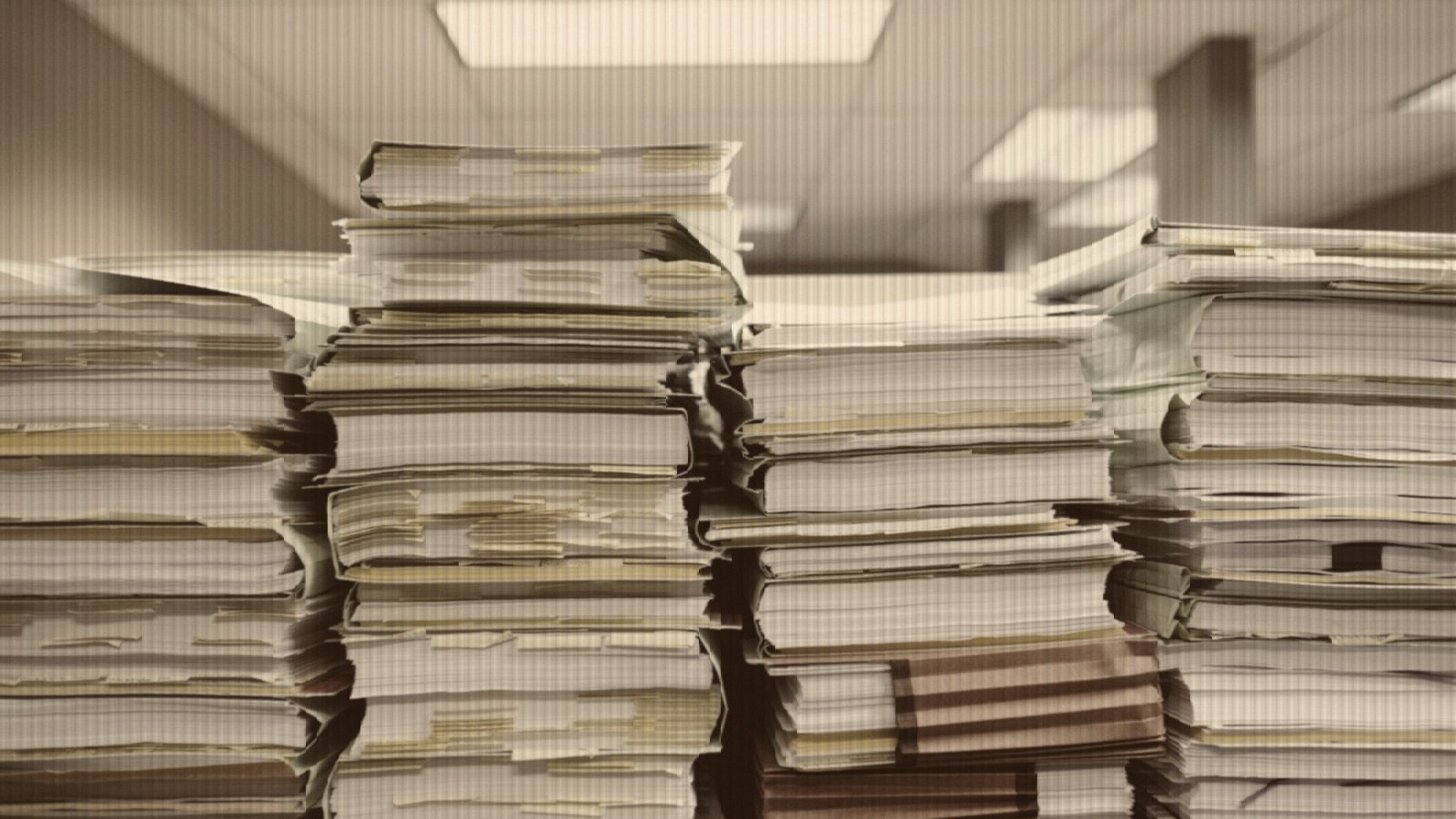 Stacks of paper documents and file folders
